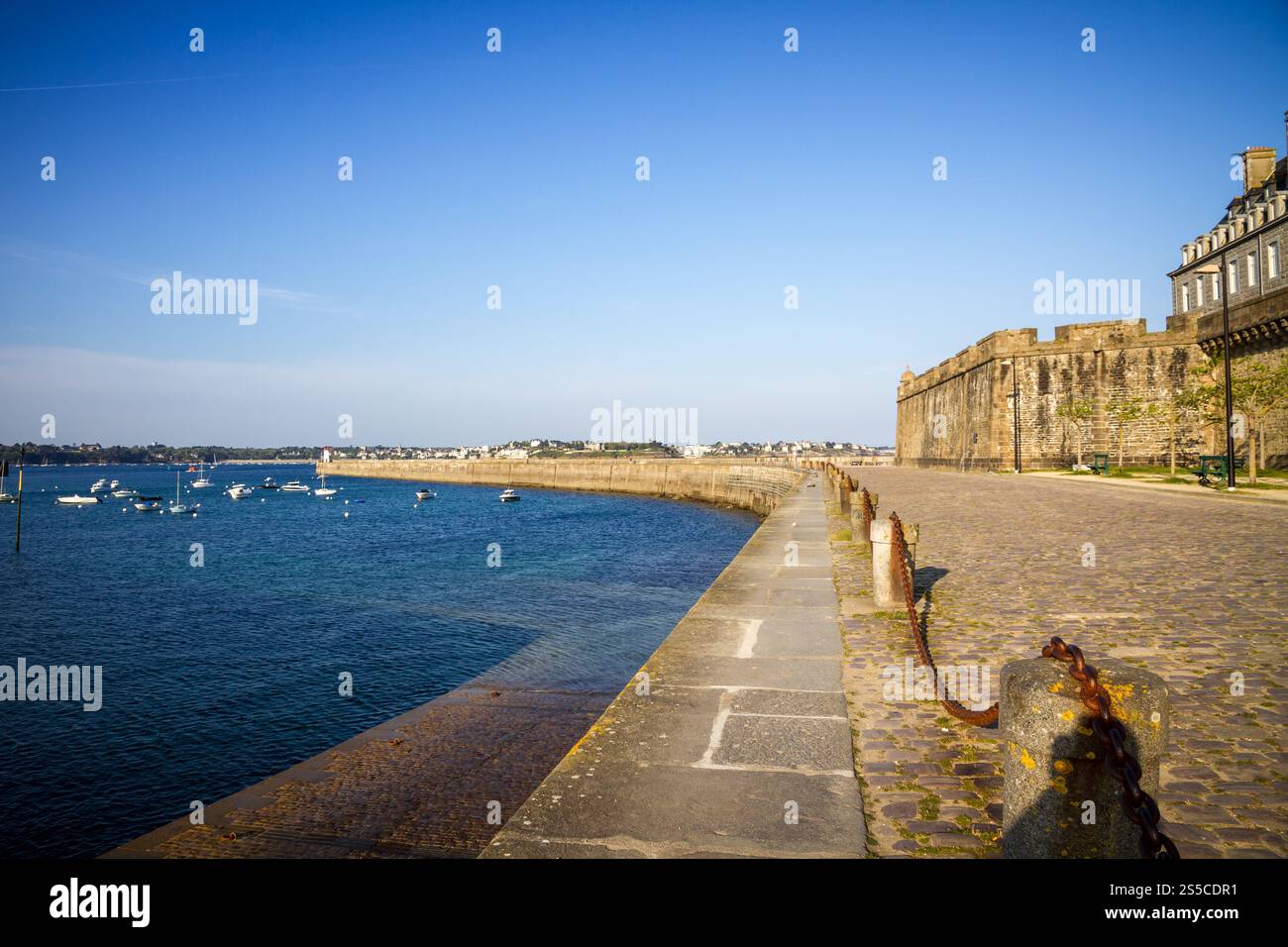 Saint-Malo lighthouse, sea and pier view from the city fortifications, Brittany, France. Saint-Malo lighthouse and pier view from the city Stock Photo
