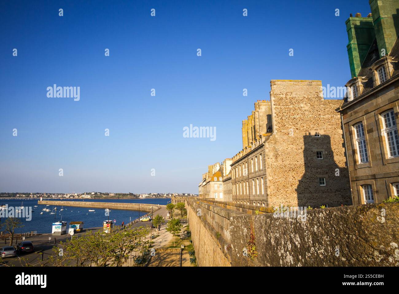 Saint-Malo lighthouse, sea and pier view from the city fortifications, Brittany, France. Saint-Malo lighthouse and pier view from the city Stock Photo