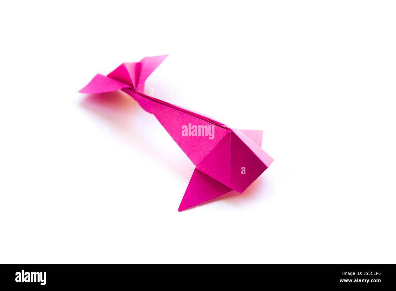 Pink paper fish origami isolated on a blank white background. Pink ...
