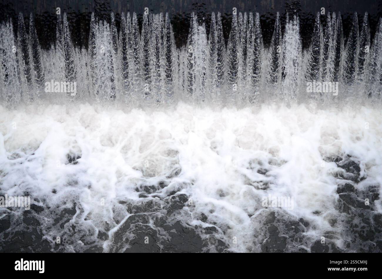 A picture of the flowing water. The dam is designed to regulate the water level in rivers within the city and to provide technical water to Stock Photo