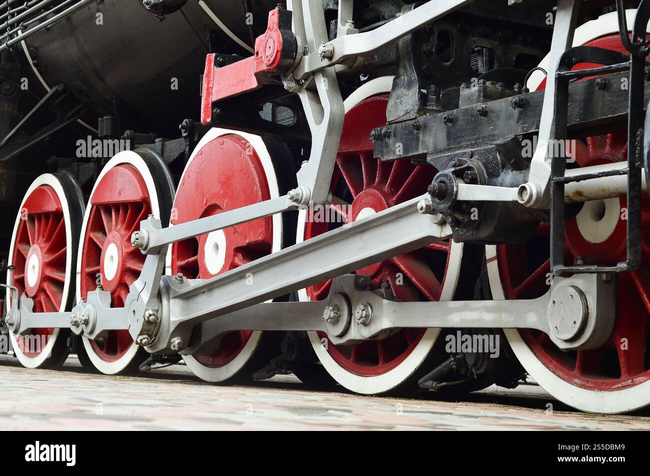 Red wheels of old USSR black steam locomotive. Wheels of an old soviet ...
