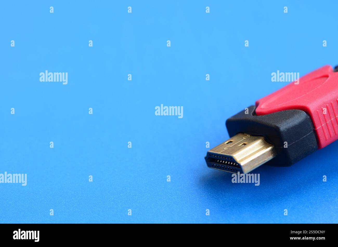 Black audio video HDMI computer cable on blue background. Close up of home entertainment connection cable for sound and video Stock Photo