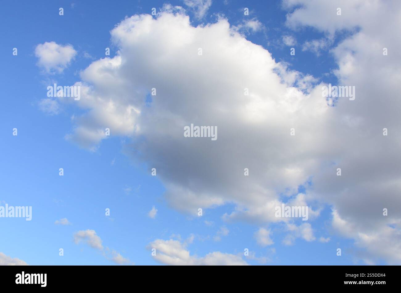 A blue sky with lots of white clouds of different sizes Stock Photo - Alamy