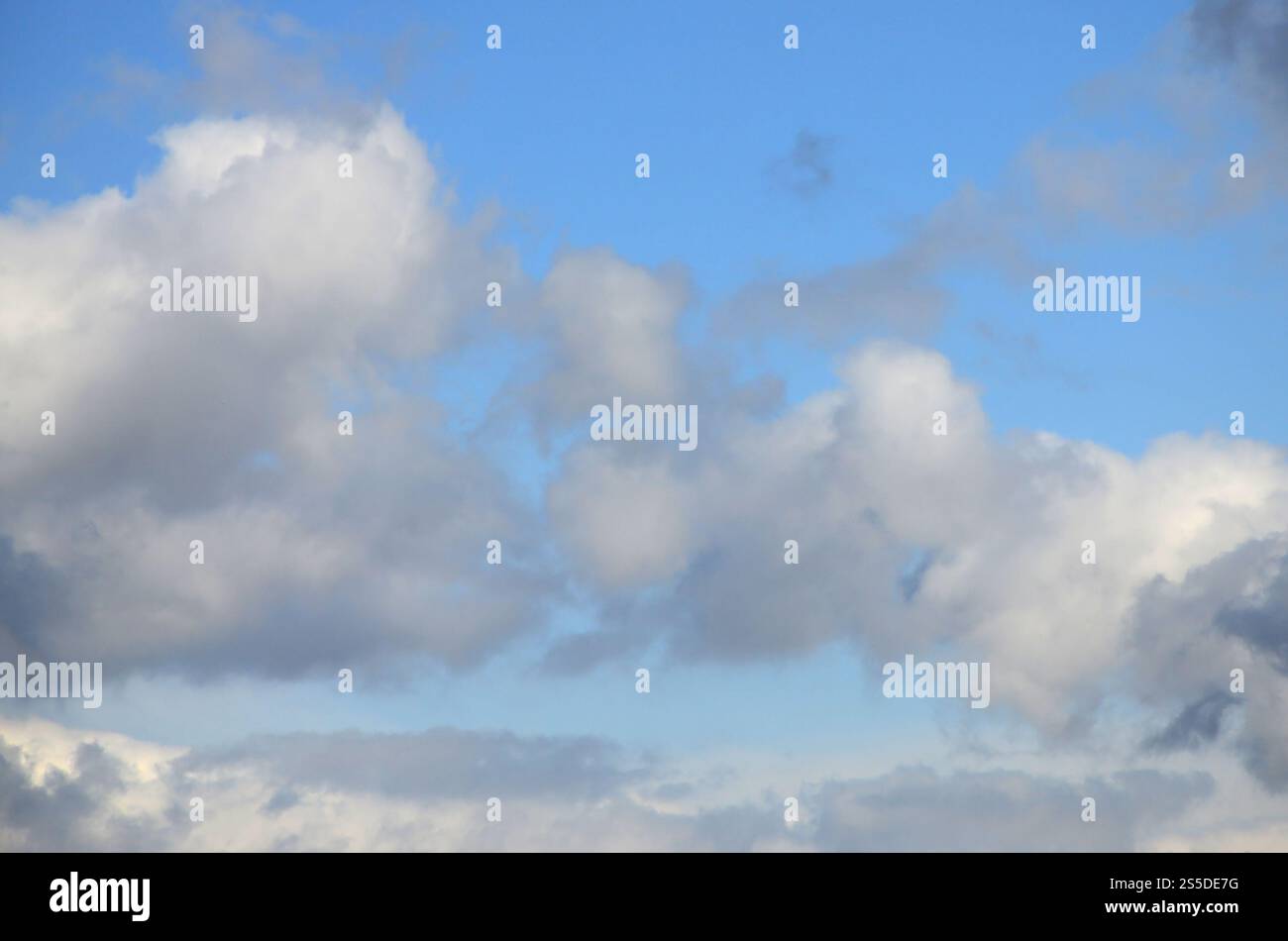 A blue sky with lots of white clouds of different sizes Stock Photo - Alamy