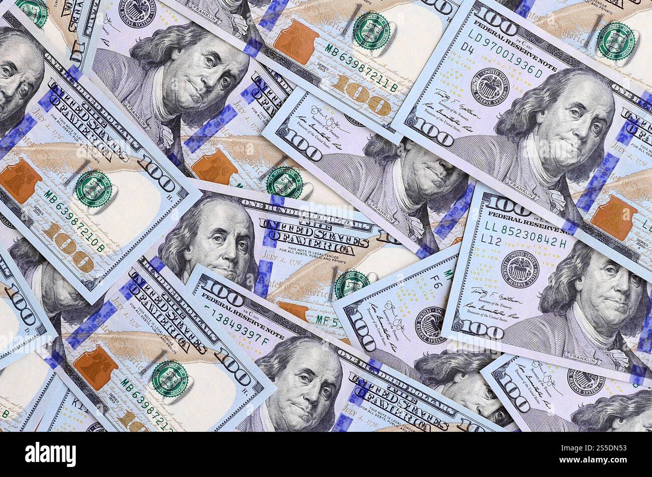 A large number of US dollar bills of a new design with a blue stripe in the middle. Top view. A large number of US dollar bills of a new design with Stock Photo