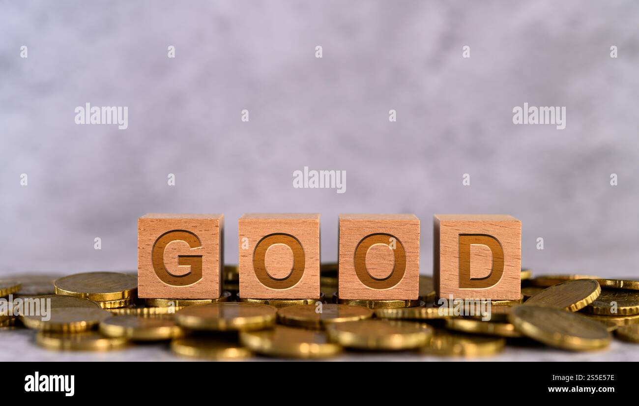 Good word alphabet wooden cube letters placed on a gold coin Stock ...