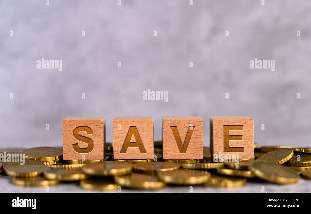 Save word alphabet wooden cube letters placed on a gold coin Stock ...