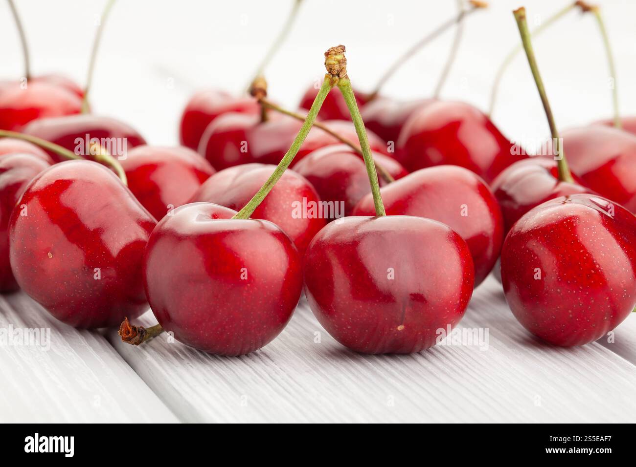 red cherry on white wood background Stock Photo