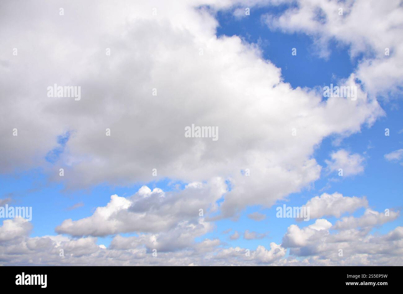 Heavenly space of blue color with a lot of thick white clouds ...