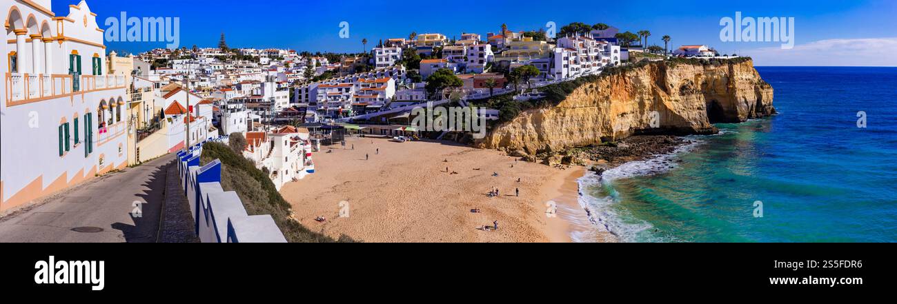 Portugal, beauiful  sunny Algarve coast. Panorama of scenic coastal town Carvoeiro with nice golden beach and white houses Stock Photo