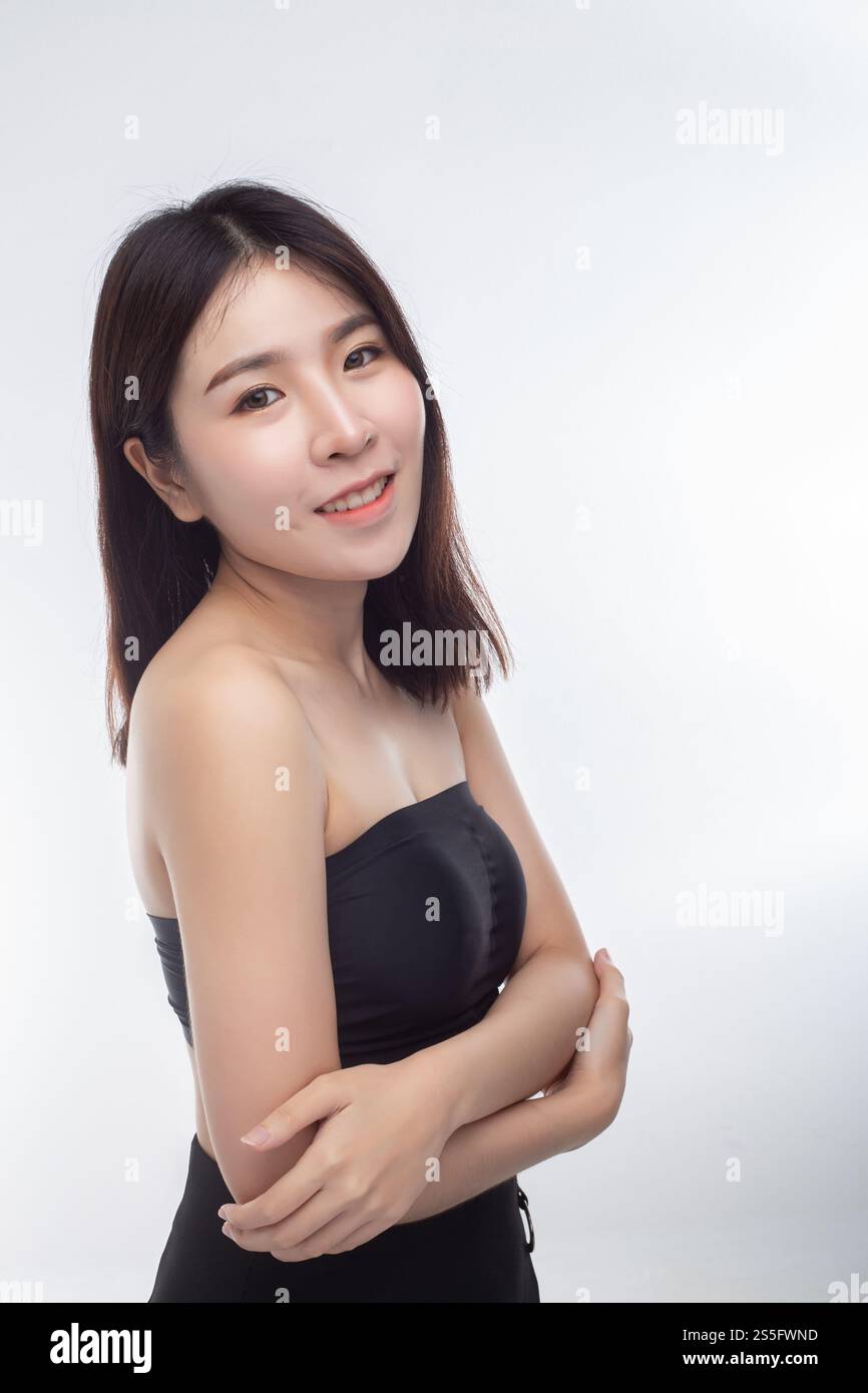 Women wearing black strapless blouses Turn your head to the right and grasp her arm. Stock Photo