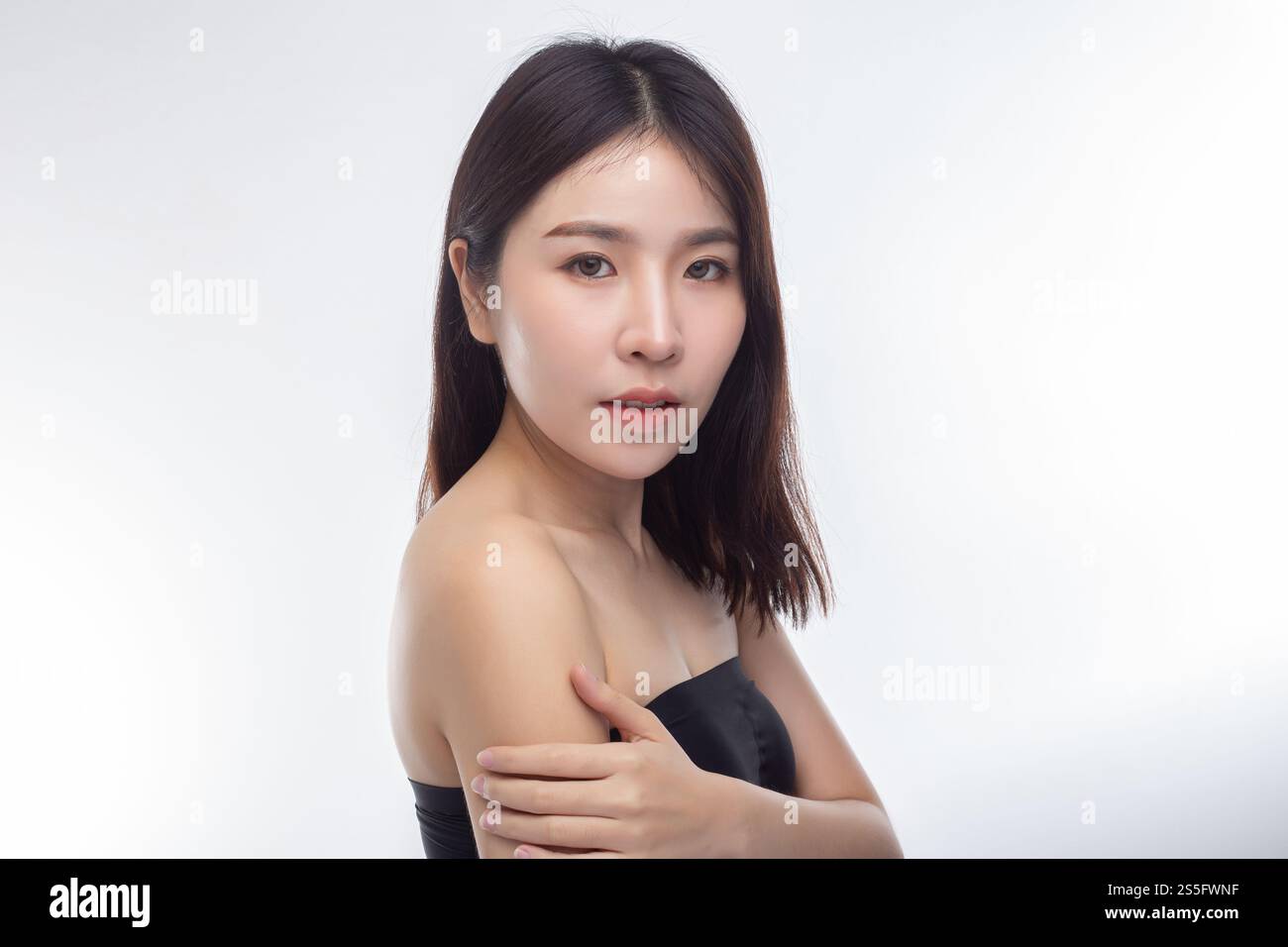 Women wearing black strapless blouses Turn your head to the right and grasp her arm. Stock Photo