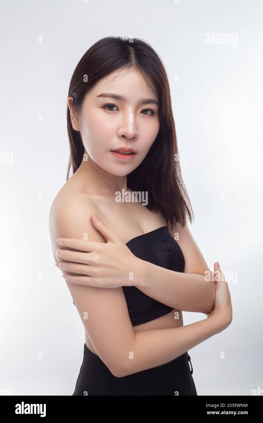 Women wearing black strapless blouses Turn your head to the right and grasp her arm. Stock Photo