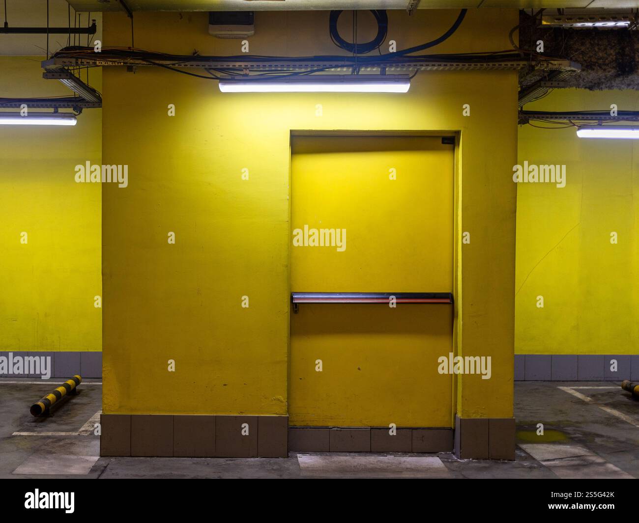 closed yellow door of exit from underground parking Stock Photo - Alamy