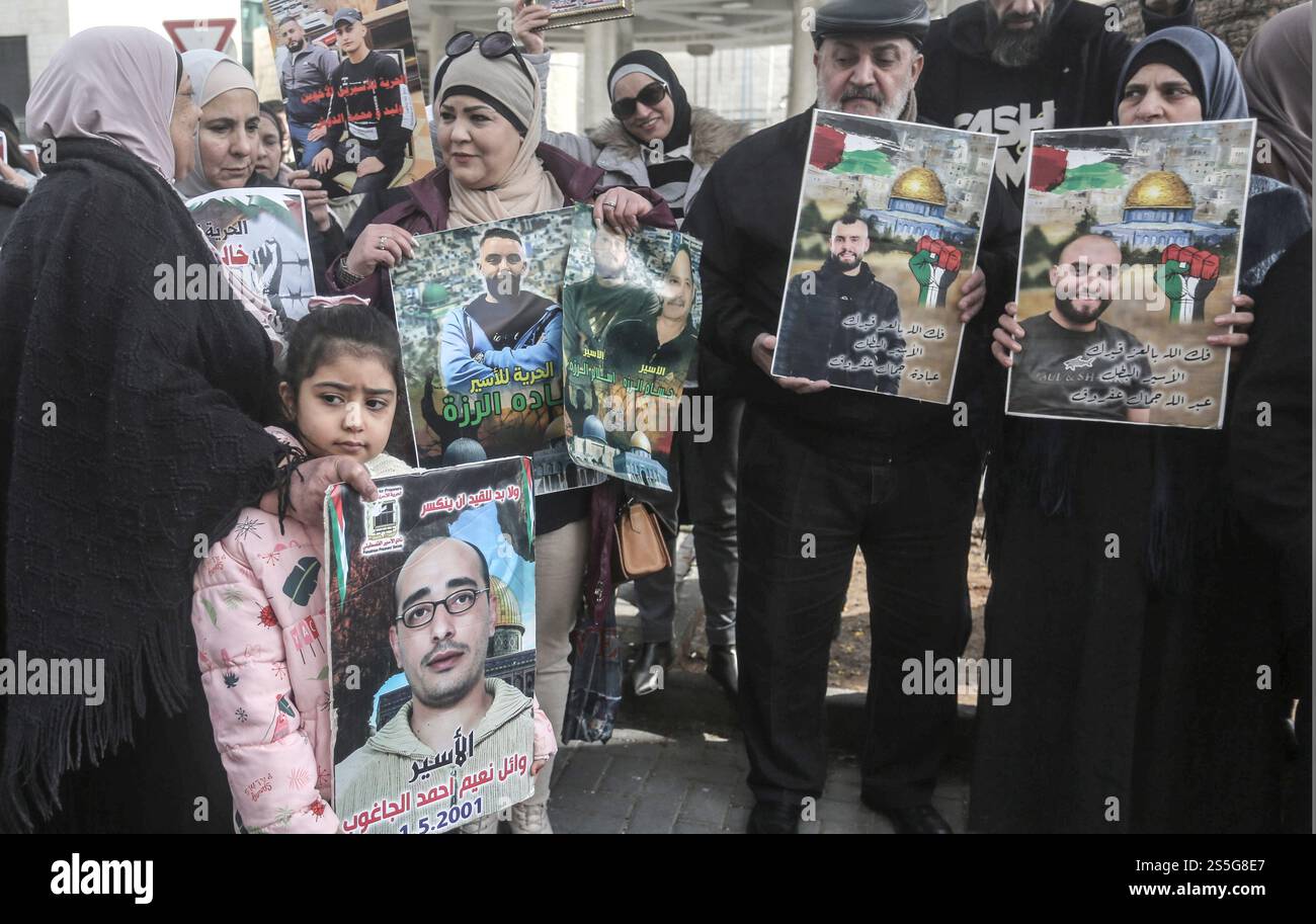 Nablus, Palestine. 14th Jan, 2025. A Palestinian girl holds a poster of her brother, a Palestinian prisoner in an Israeli occupation prison, demanding a prisoner exchange agreement between Hamas and Israel, during a demonstration in solidarity with Palestinian prisoners in the city of Nablus in the West Bank. Credit: SOPA Images Limited/Alamy Live News Stock Photo