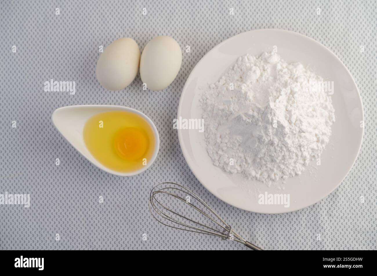 Eggs, tapioca flour and an egg beater, ingredients used in bakery Stock ...