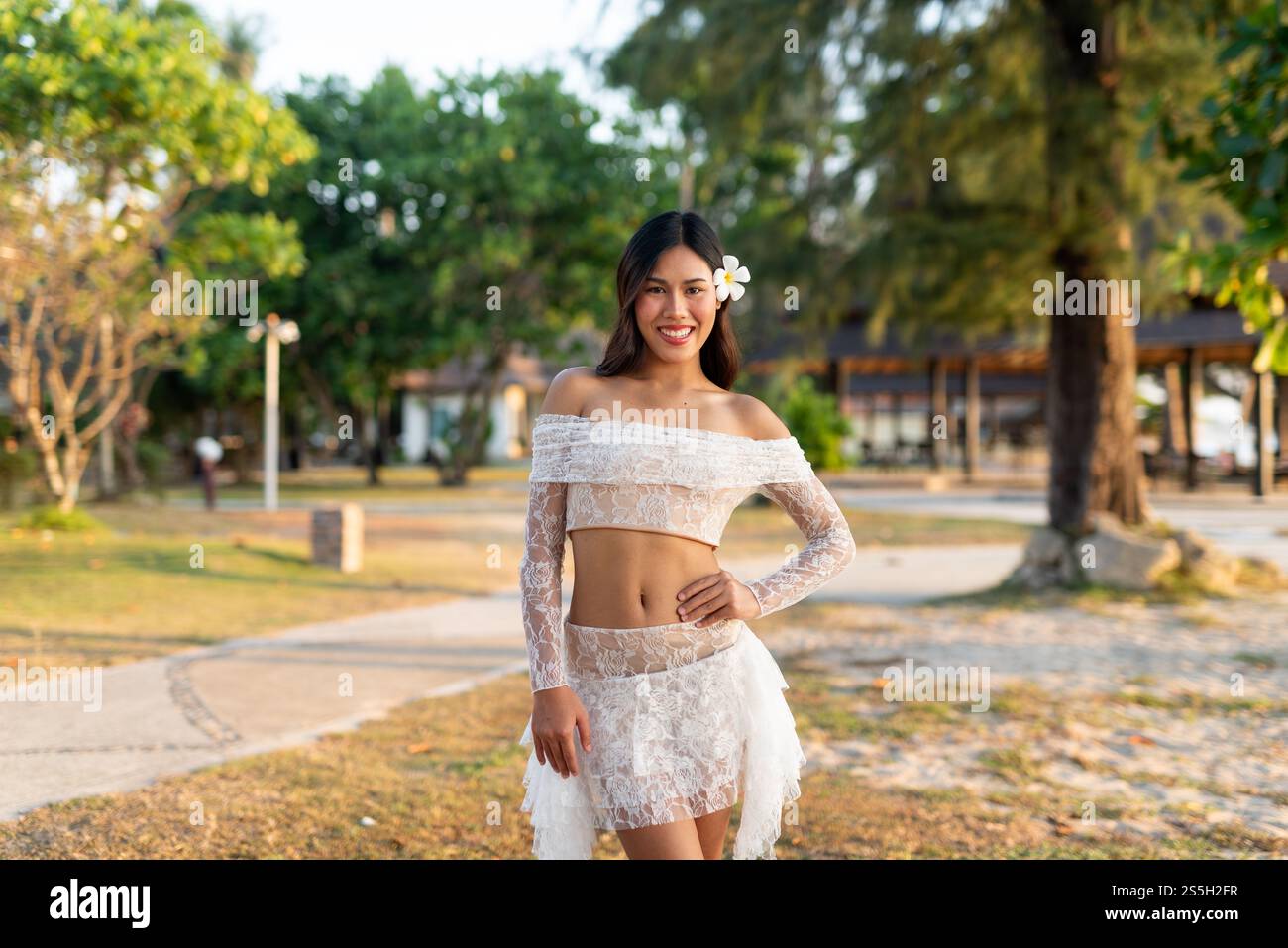 Beautiful woman in a park smiling Stock Photo - Alamy
