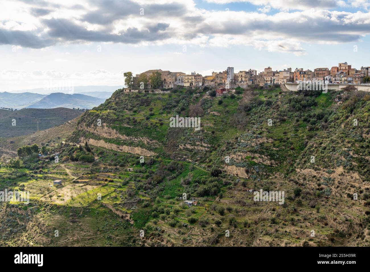 Small village of Centuripe and picturesque Sicilian Countryside Landscape: Rolling Hills, Verdant Terraces, Rural Farmhouses, and Olive Groves under S Stock Photo