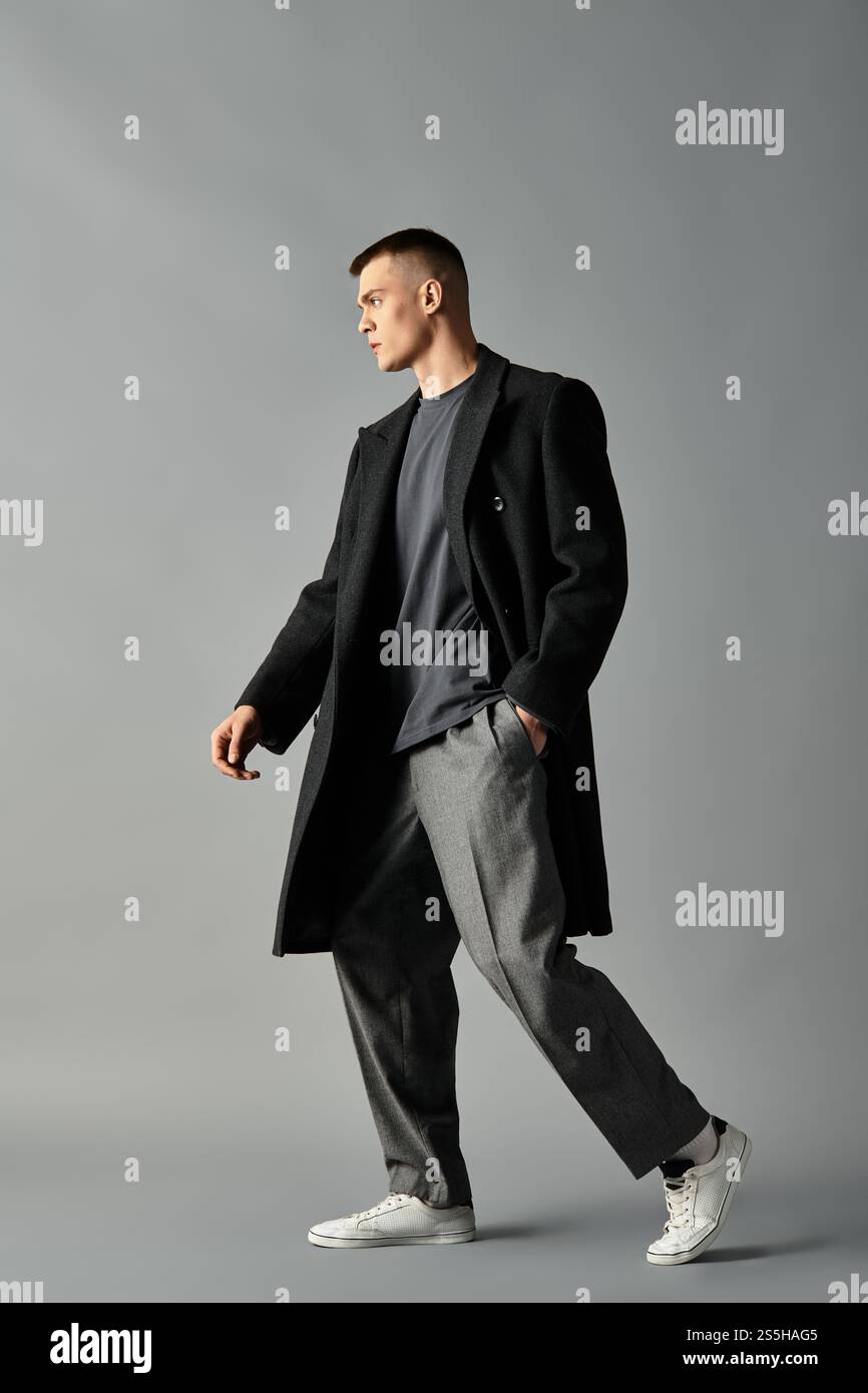 A young man showcases a modern outfit, confidently walking in a ...