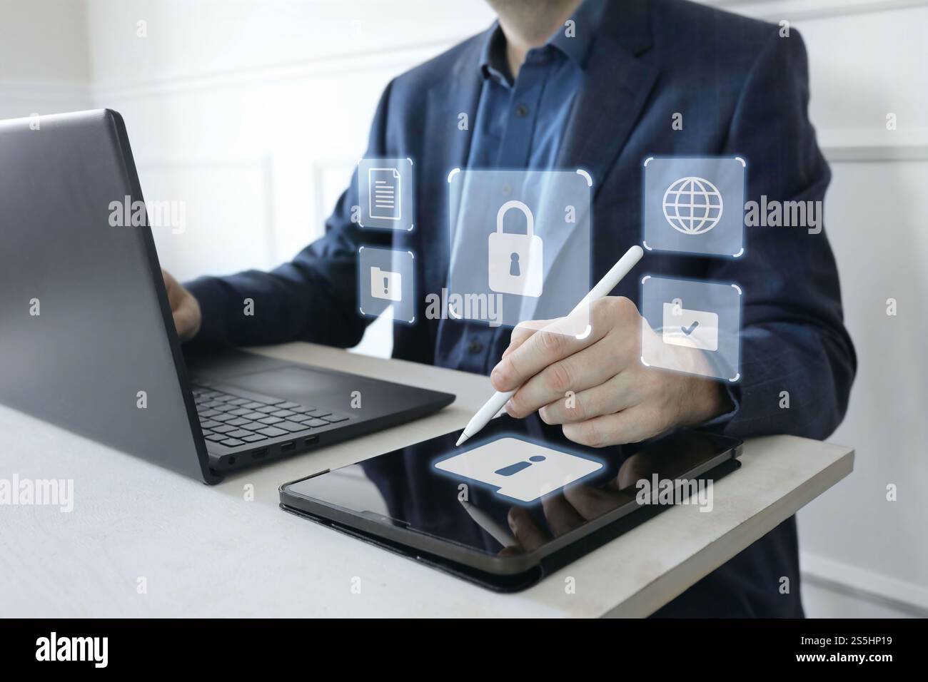 Man in suit working on laptop, digital tablet. Cyber security shield, lock. Glowing icons of computer alerts, folders. Protection of sensitive data Stock Photo
