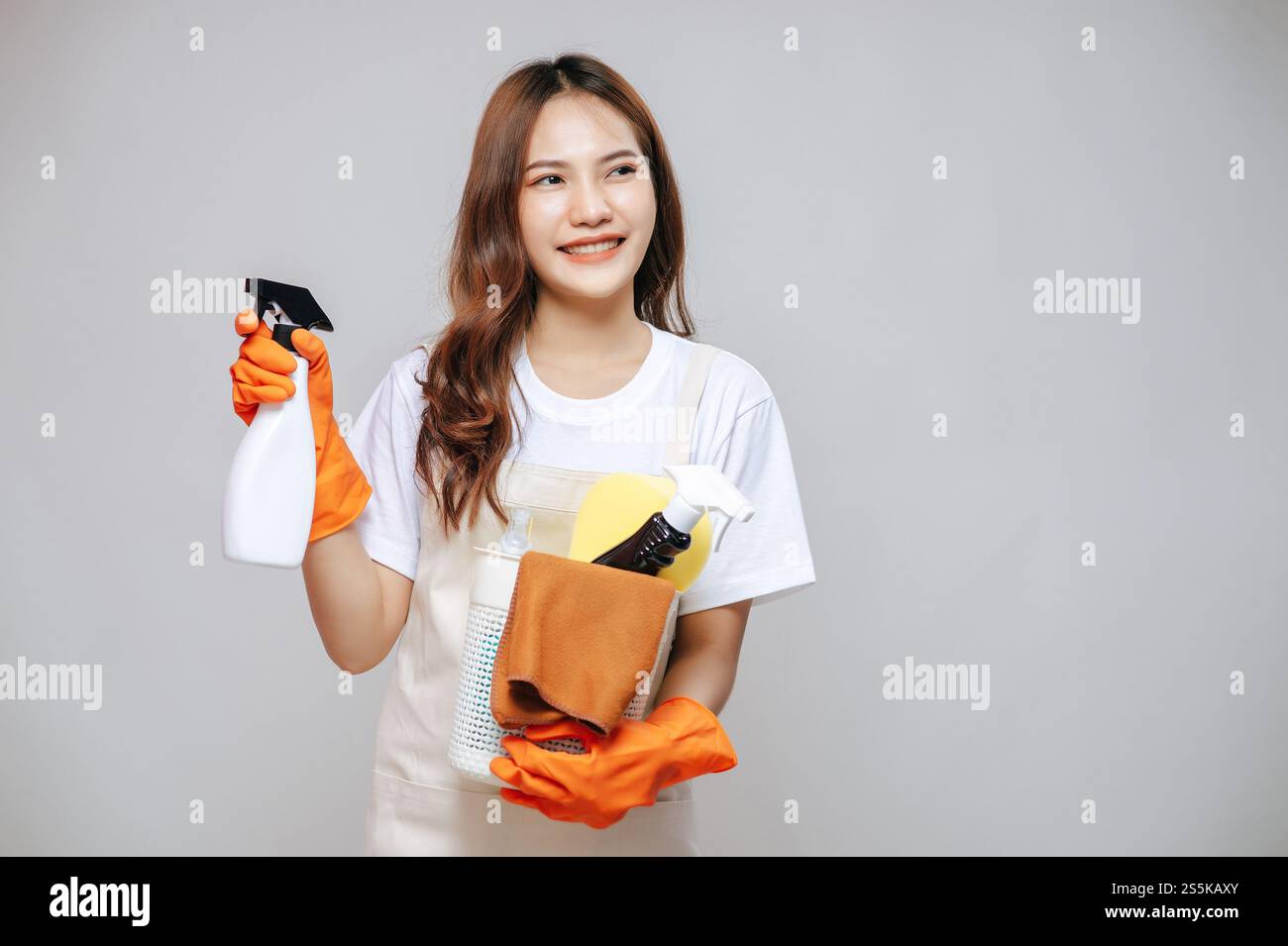 Portrait young asian woman in apron and rubber gloves, smile and ...