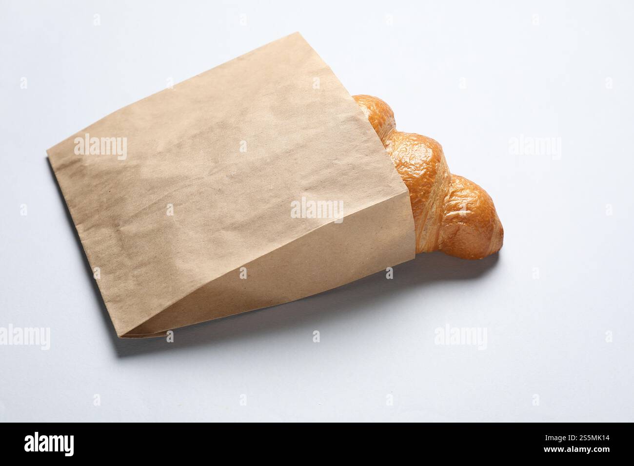 Paper bag with fresh croissant on white background Stock Photo - Alamy