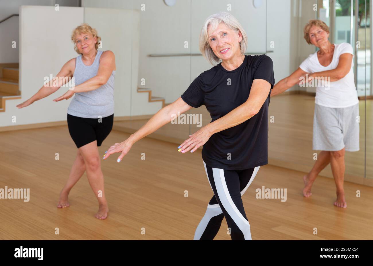 Active mature woman learning dynamic dances in choreography class Stock Photo
