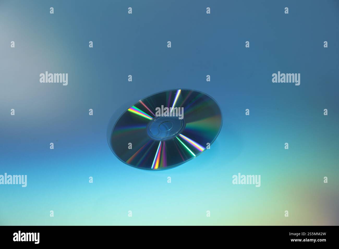 One shiny compact disc on light blue background Stock Photo