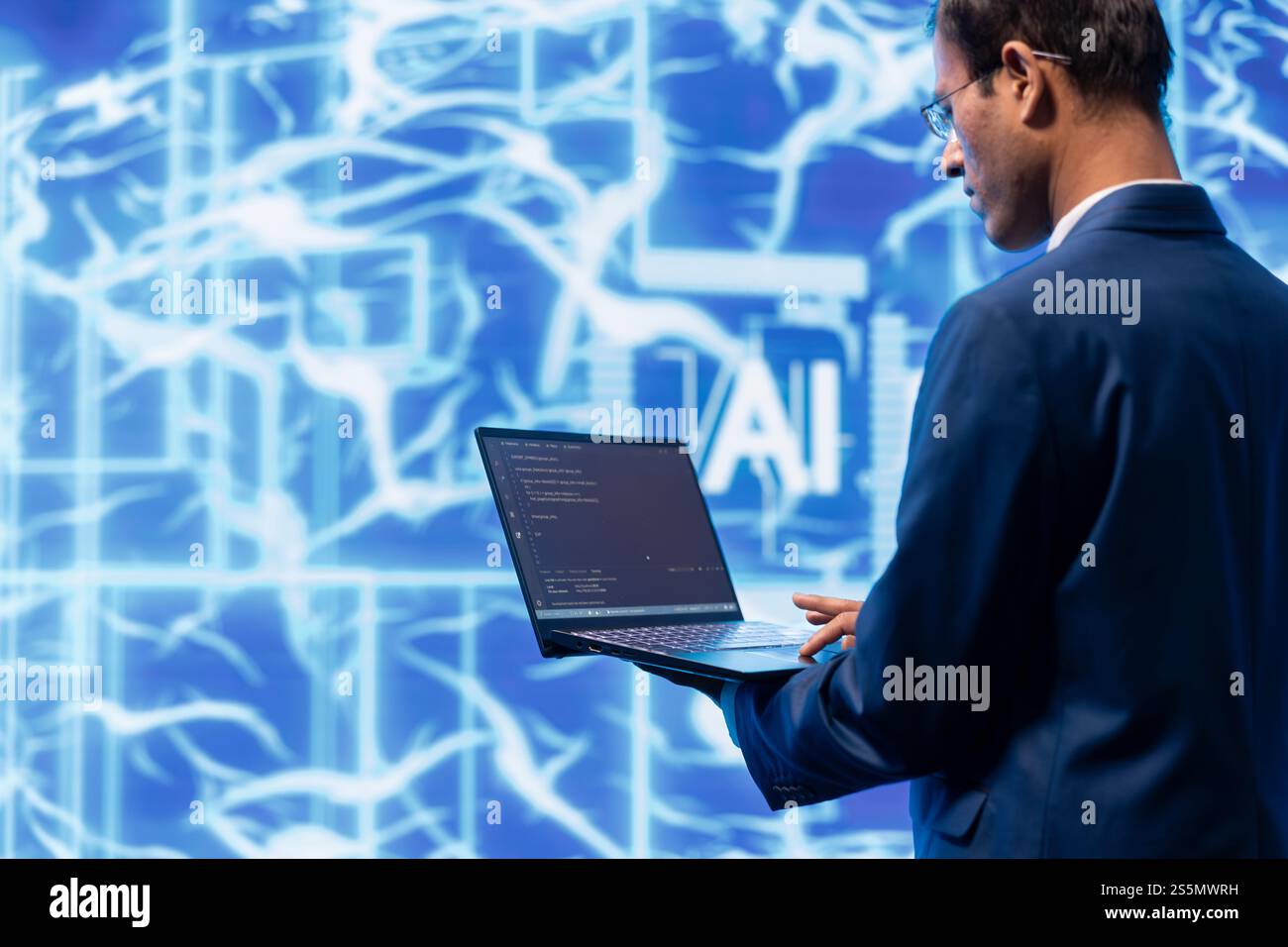 System administrator solving tasks on laptop, running artificial intelligence programming scripts. Technician manipulating lines of code for AI applications development on notebook Stock Photo