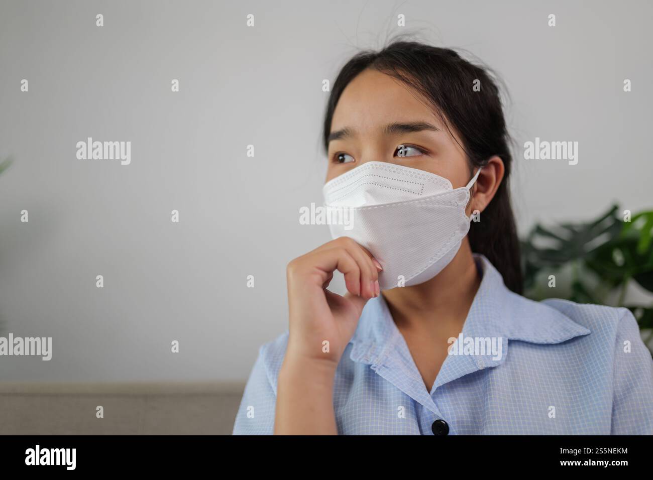 Headshot protrait lovely woman wearing protective face mask during quarantine covid-19 self isolation at home, work from home concept Stock Photo