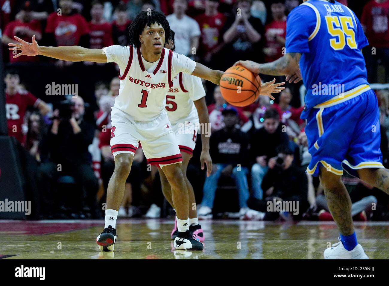 Michael Clark Rutgers Rutgers guard Jamichael Davis (1), left, guards UCLA guard Skyy Clark ...