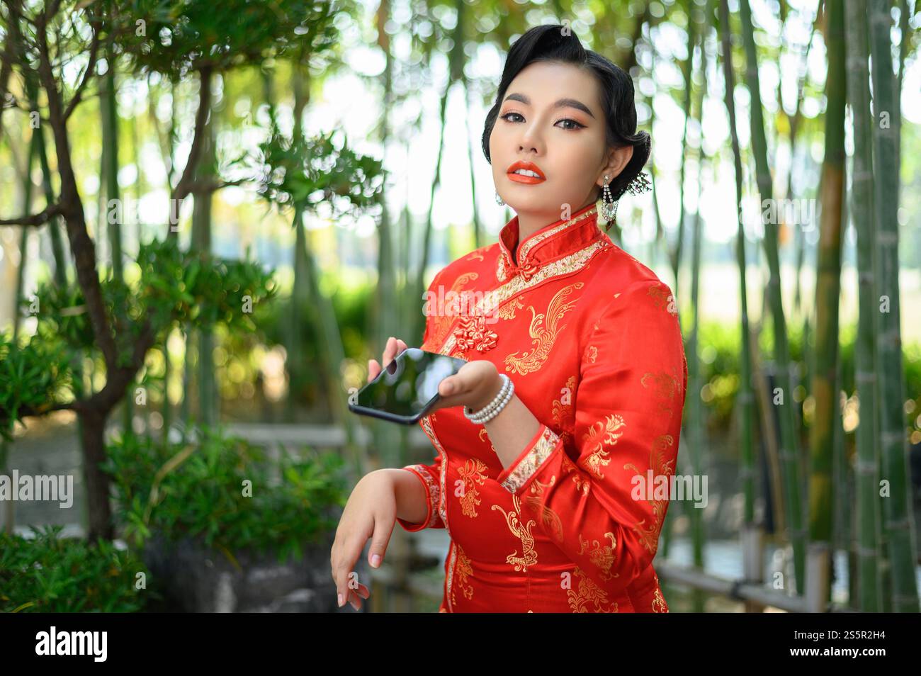 Portrait pretty Asian woman in a Chinese cheongsam posing with ...