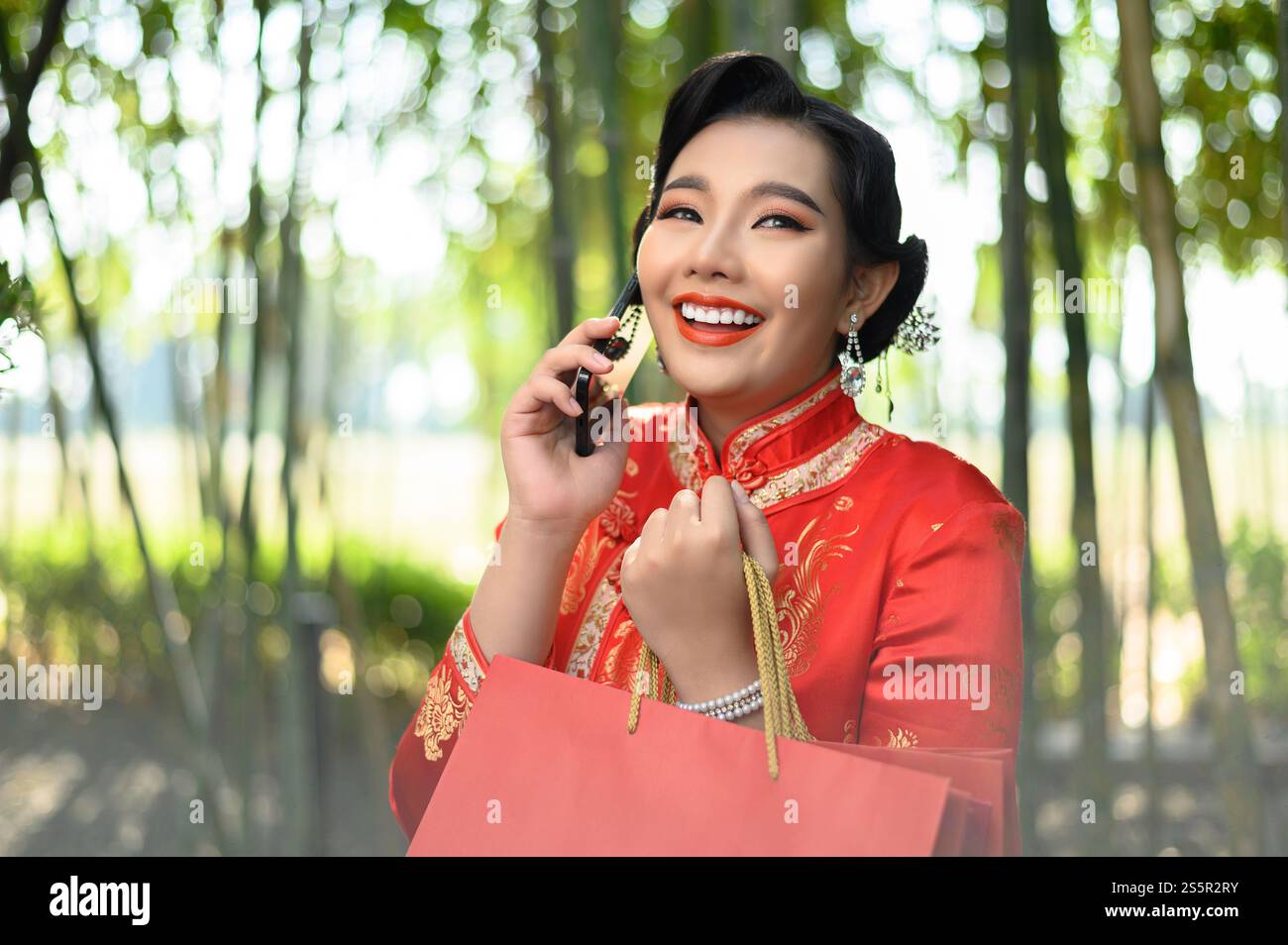 Portrait pretty Asian woman in a Chinese cheongsam holding shopping ...