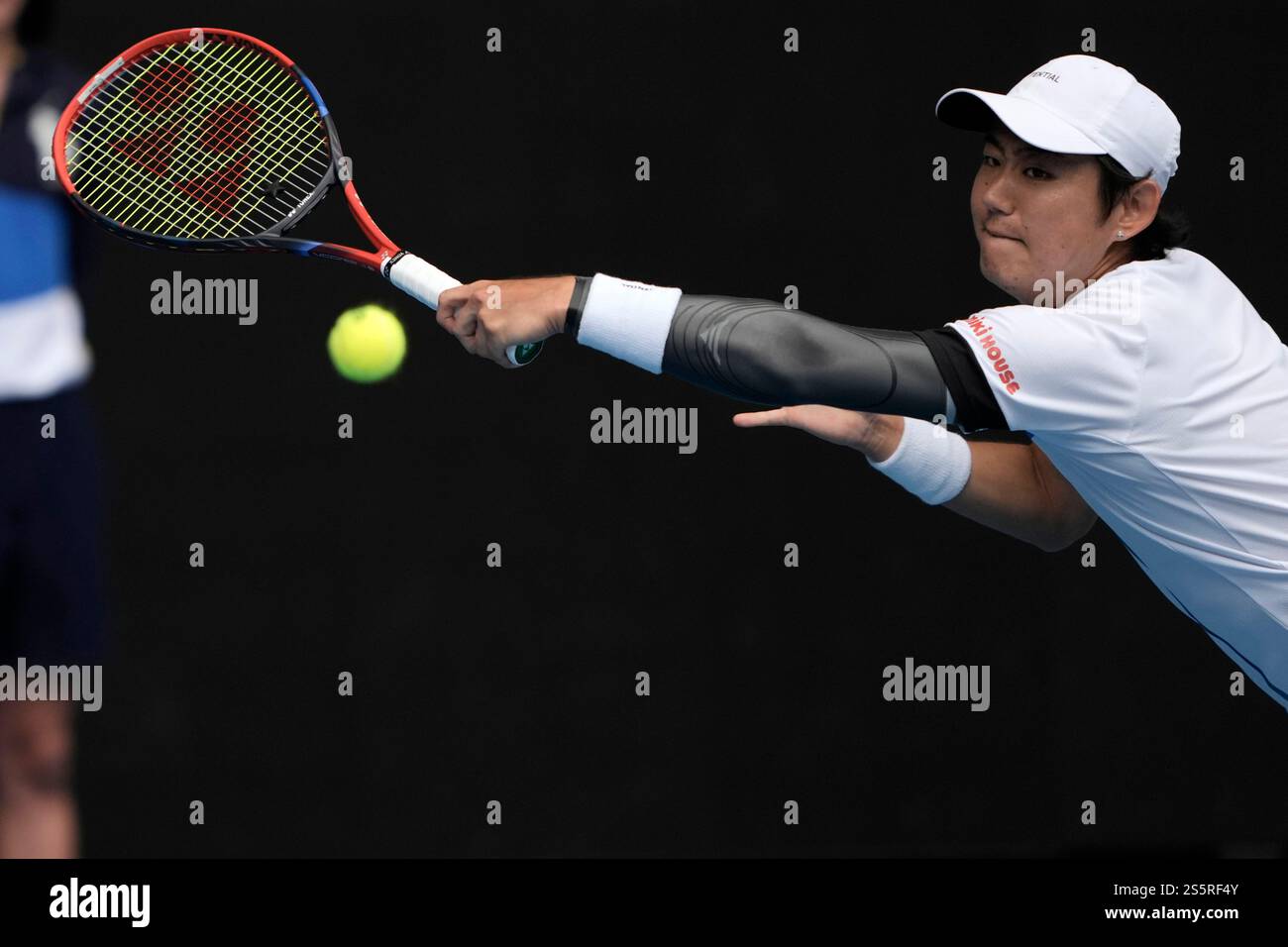 Yoshihito Nishioka of Japan plays a backhand return to Carlos Alcaraz