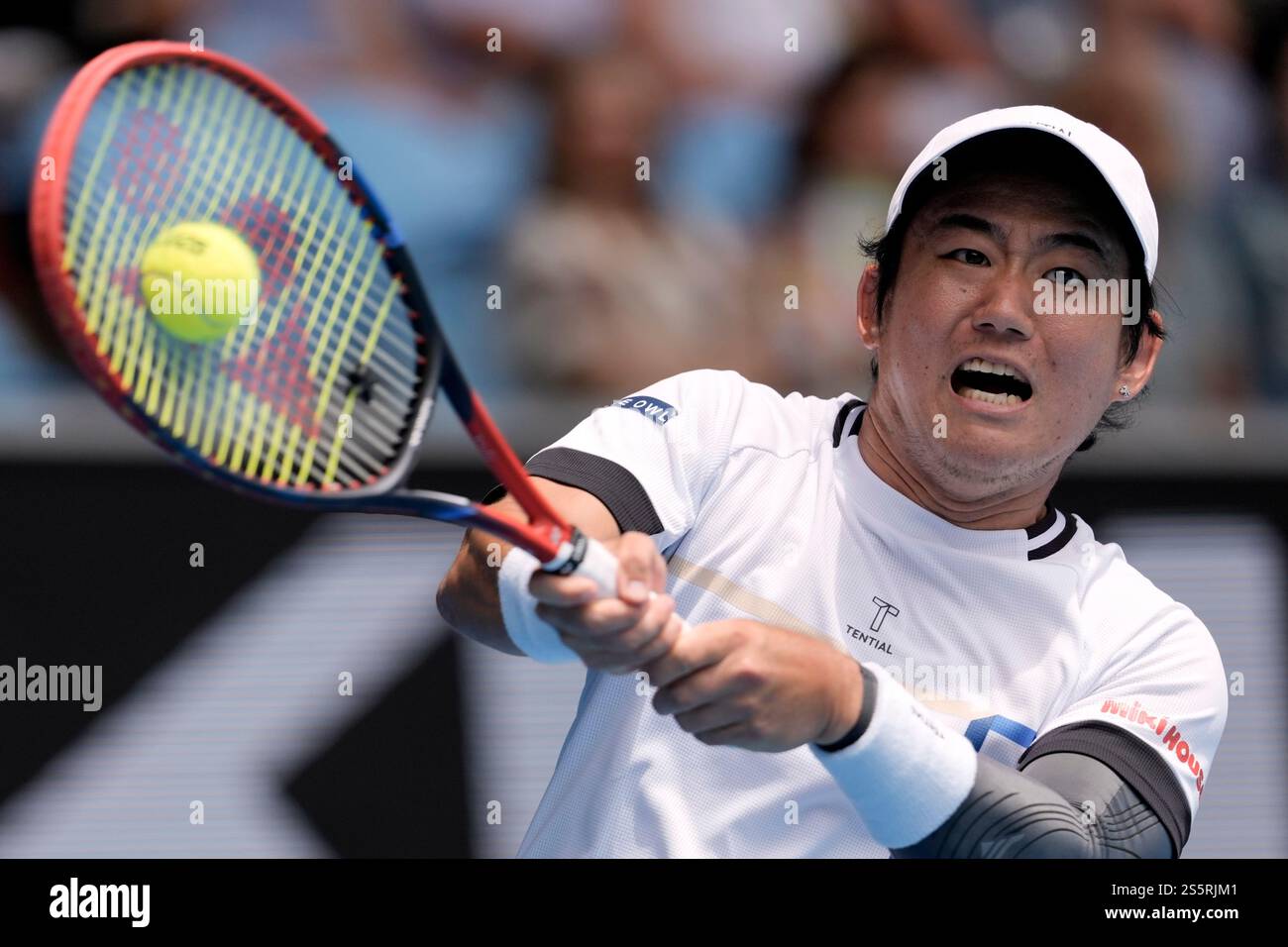 Yoshihito Nishioka of Japan plays a backhand return to Carlos Alcaraz