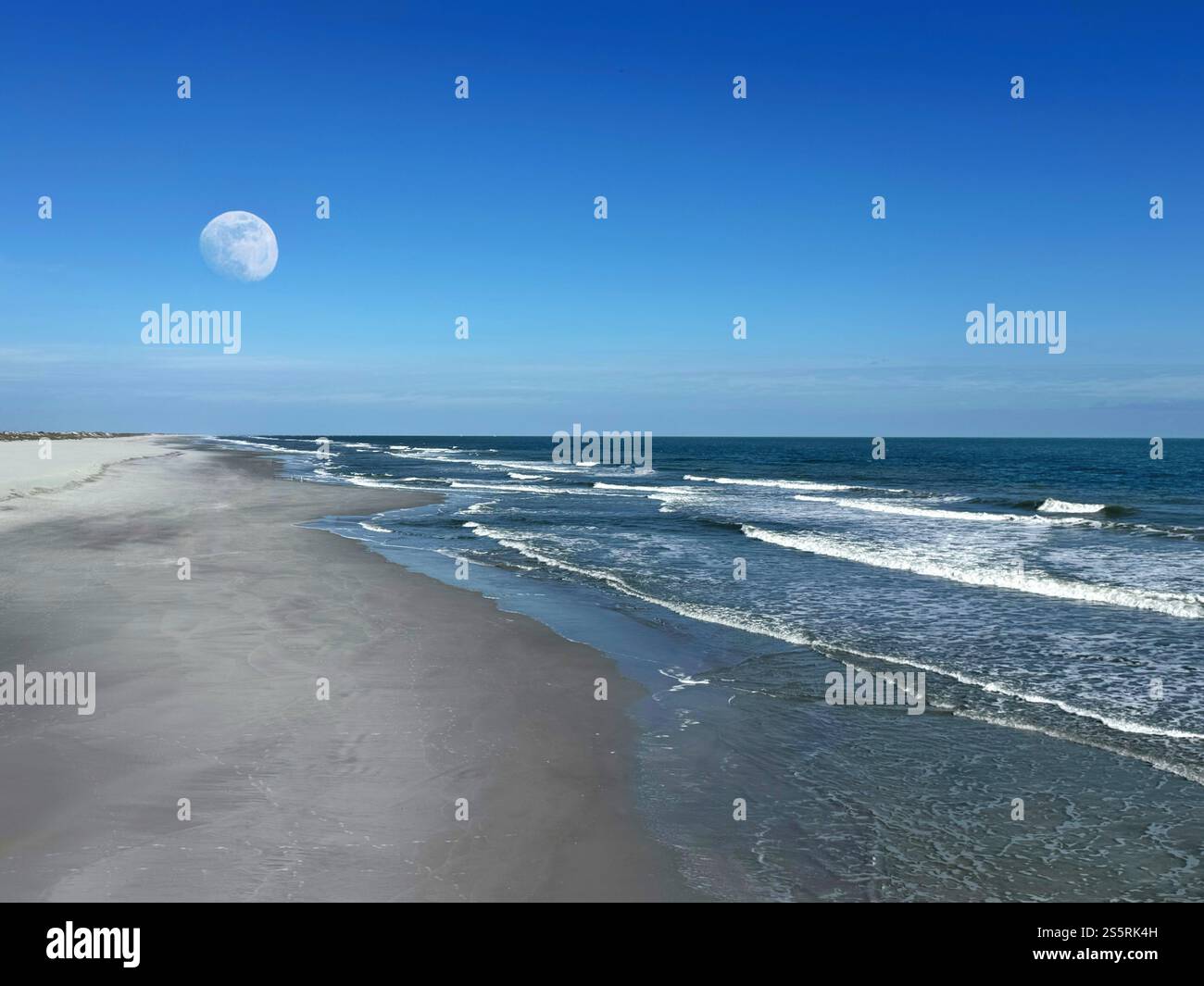 Moon above a beach with breaking waves - Smartphone Captured Stock Image