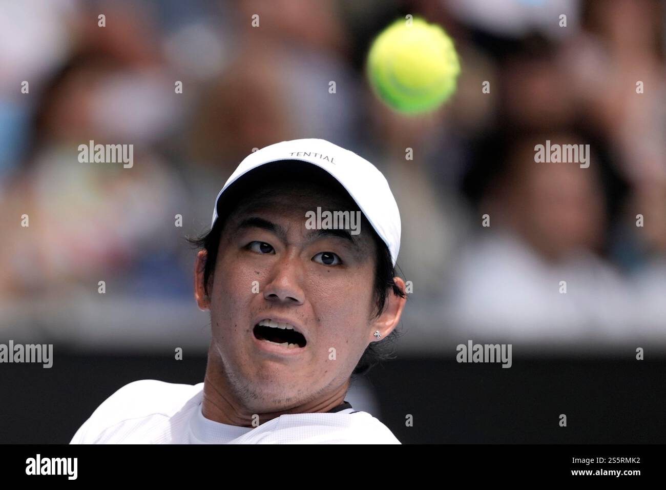 Yoshihito Nishioka of Japan plays a backhand return to Carlos Alcaraz