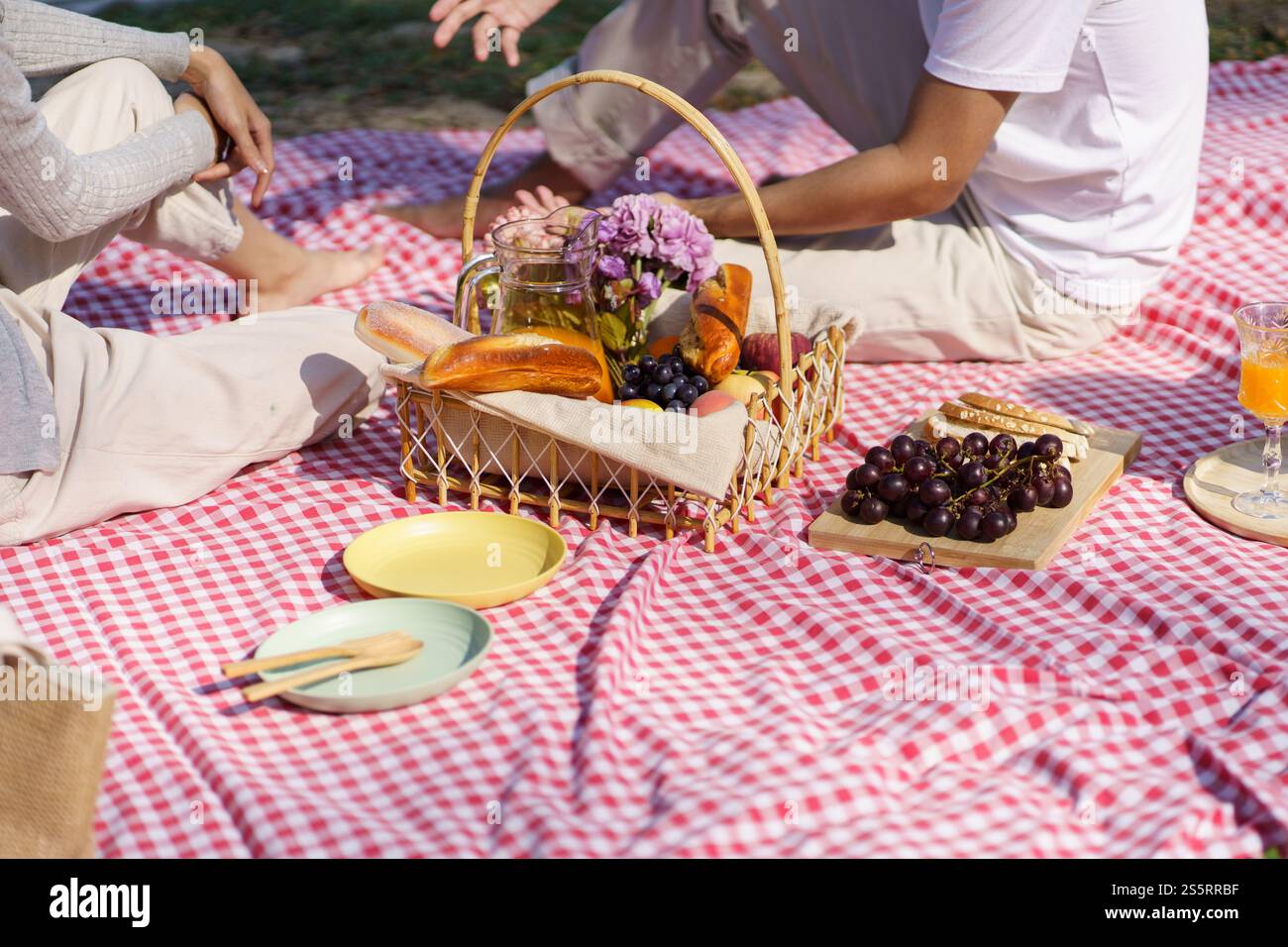 In love couple enjoying picnic time in park outdoors Picnic. happy couple relaxing together with picnic Basket. Stock Photo