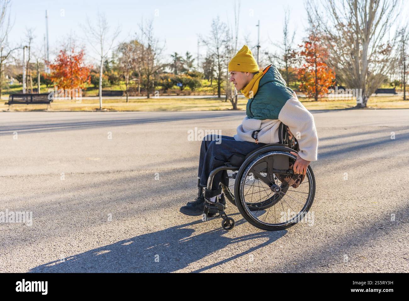 Person using a wheelchair enjoying a sunny day in a park, promoting ...