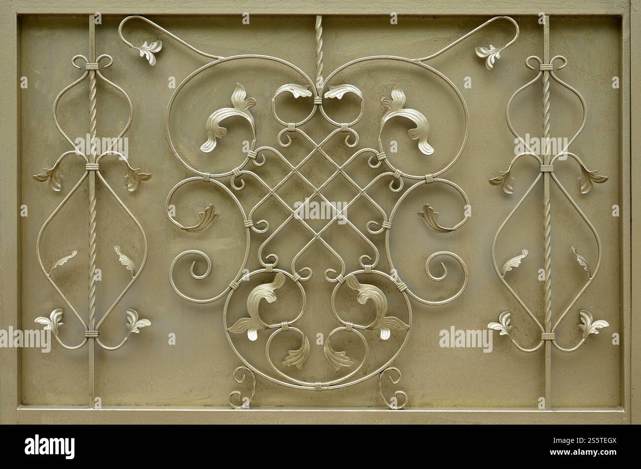 The texture of the golden metal gate with a beautiful floral pattern of forged metal Stock Photo