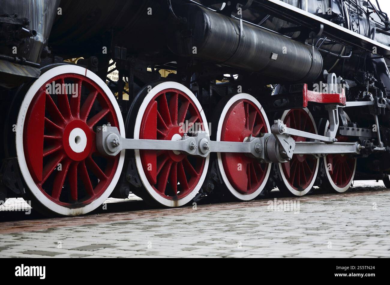 Red wheels of old USSR black steam locomotive. Wheels of an old soviet ...