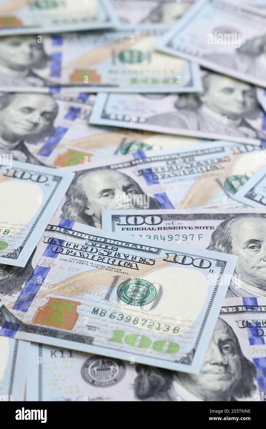 A large number of US dollar bills of a new design with a blue stripe in the middle. Top view. A large number of US dollar bills of a new design with Stock Photo