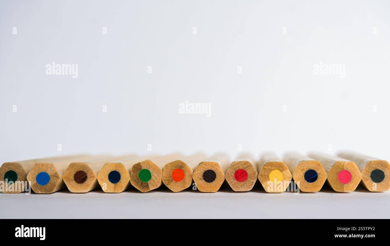 Kid education concept. Color pencils on white paper background. copy space for text Stock Photo