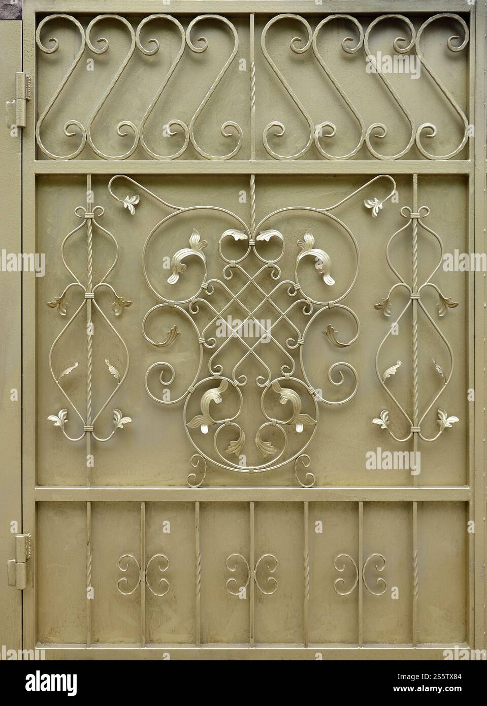The texture of the golden metal gate with a beautiful floral pattern of forged metal Stock Photo