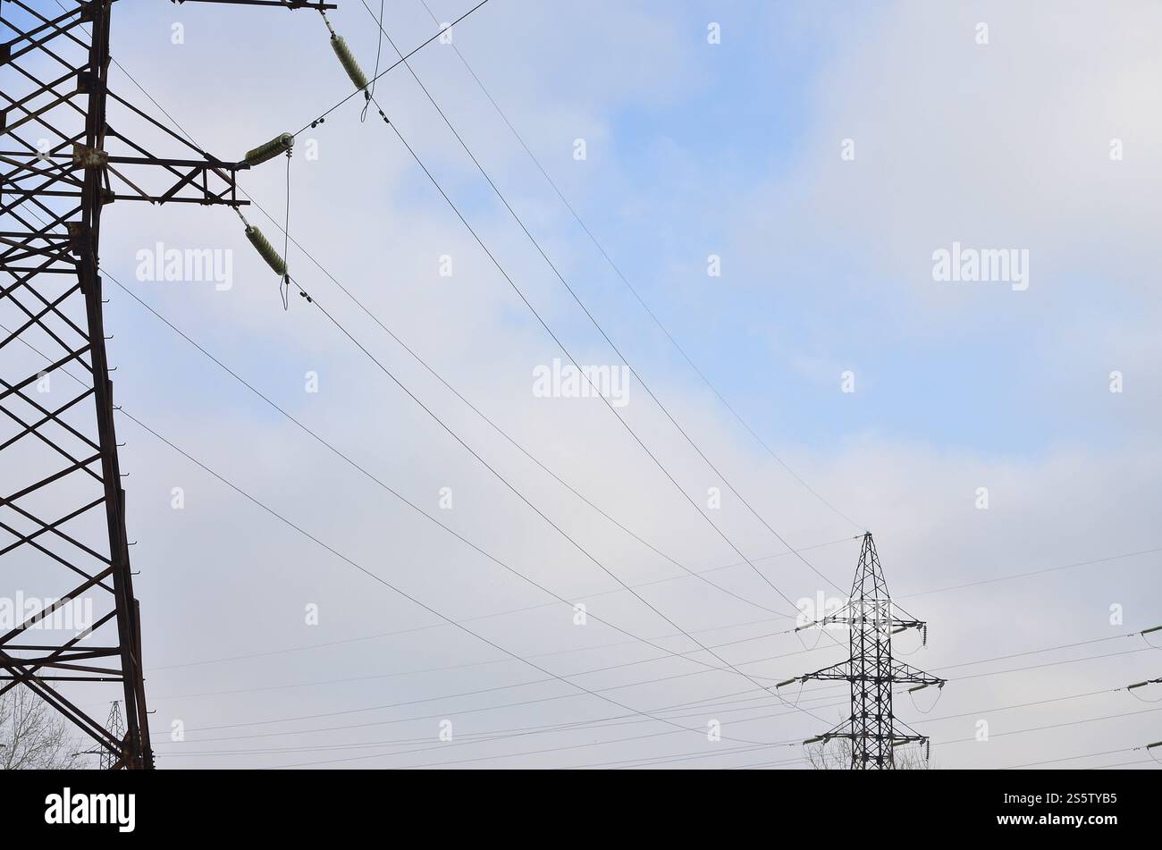 The silhouette of the electricity transmission pylon in daytime outdoors. Electricity Pylon. Russian standard overhead power line transmission tower Stock Photo