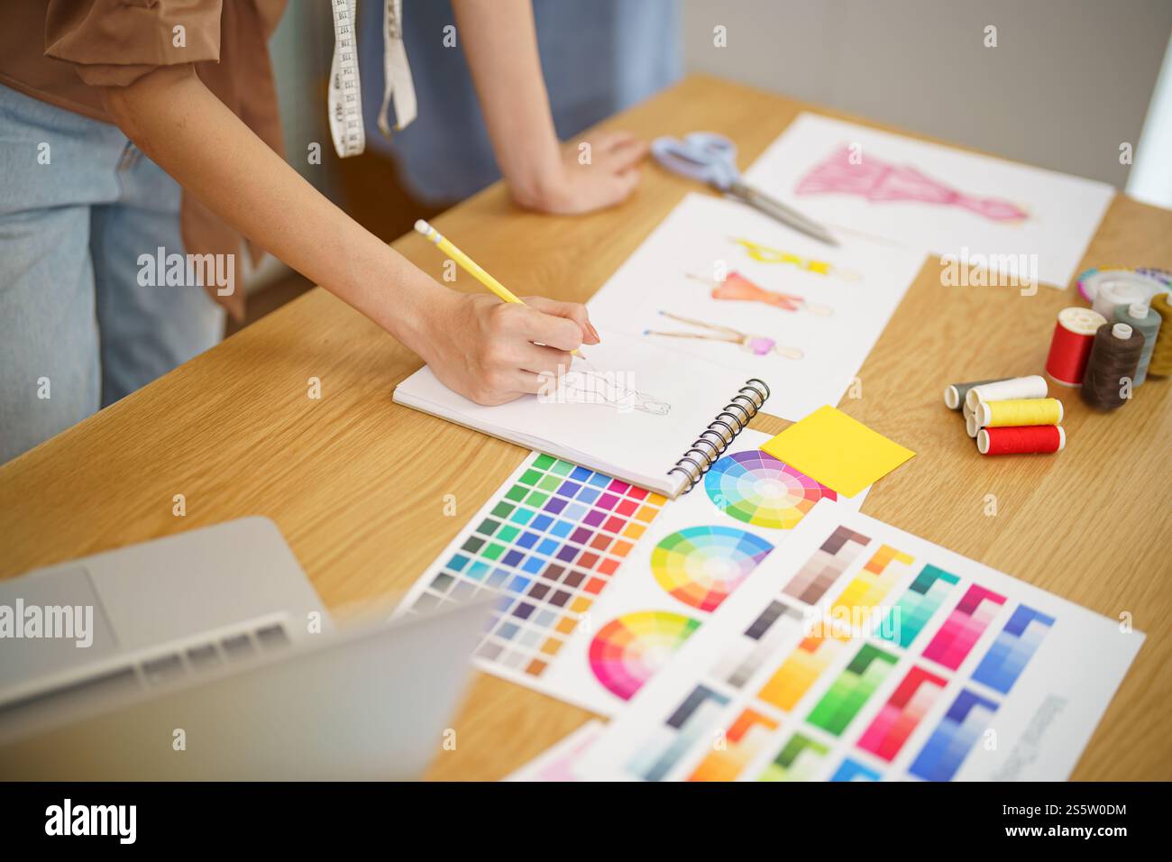 Start-up Stylish Fashion Designer work as sketch of new collection in atelier. Creative Design Concept Stock Photo