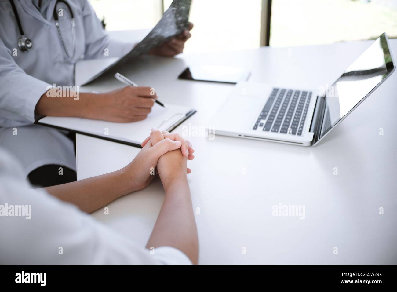 Education profession doctor in white uniform gown coat. Professional medical doctor with tablet and papers at seminar or hospital Coronavirus Stock Photo