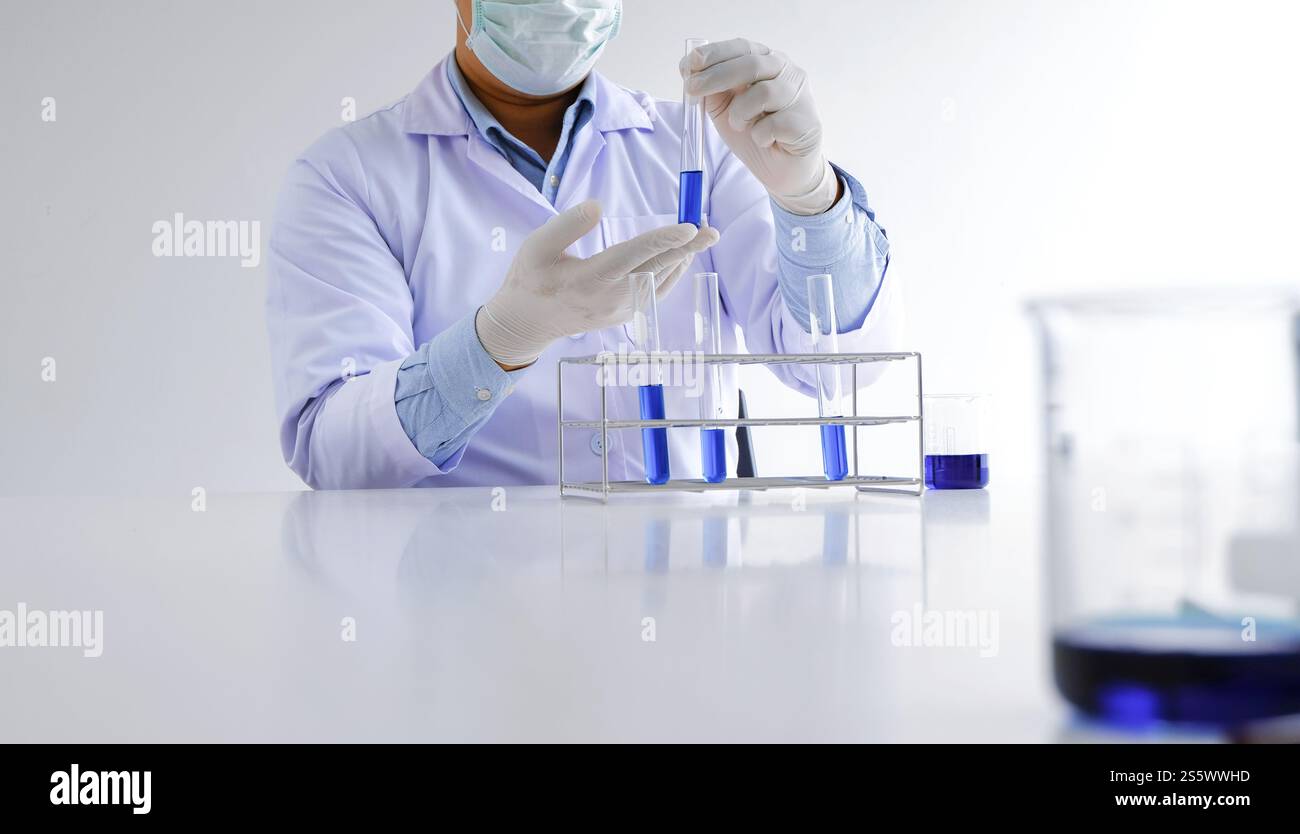 Science innovative Male medical or scientific laboratory researcher performs tests with liquid in laboratory. equipment science experiments Stock Photo