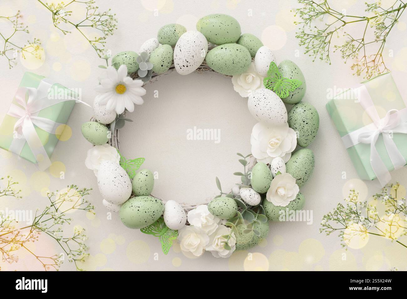 Easter wreath, flowers and gifts on light background Stock Photo