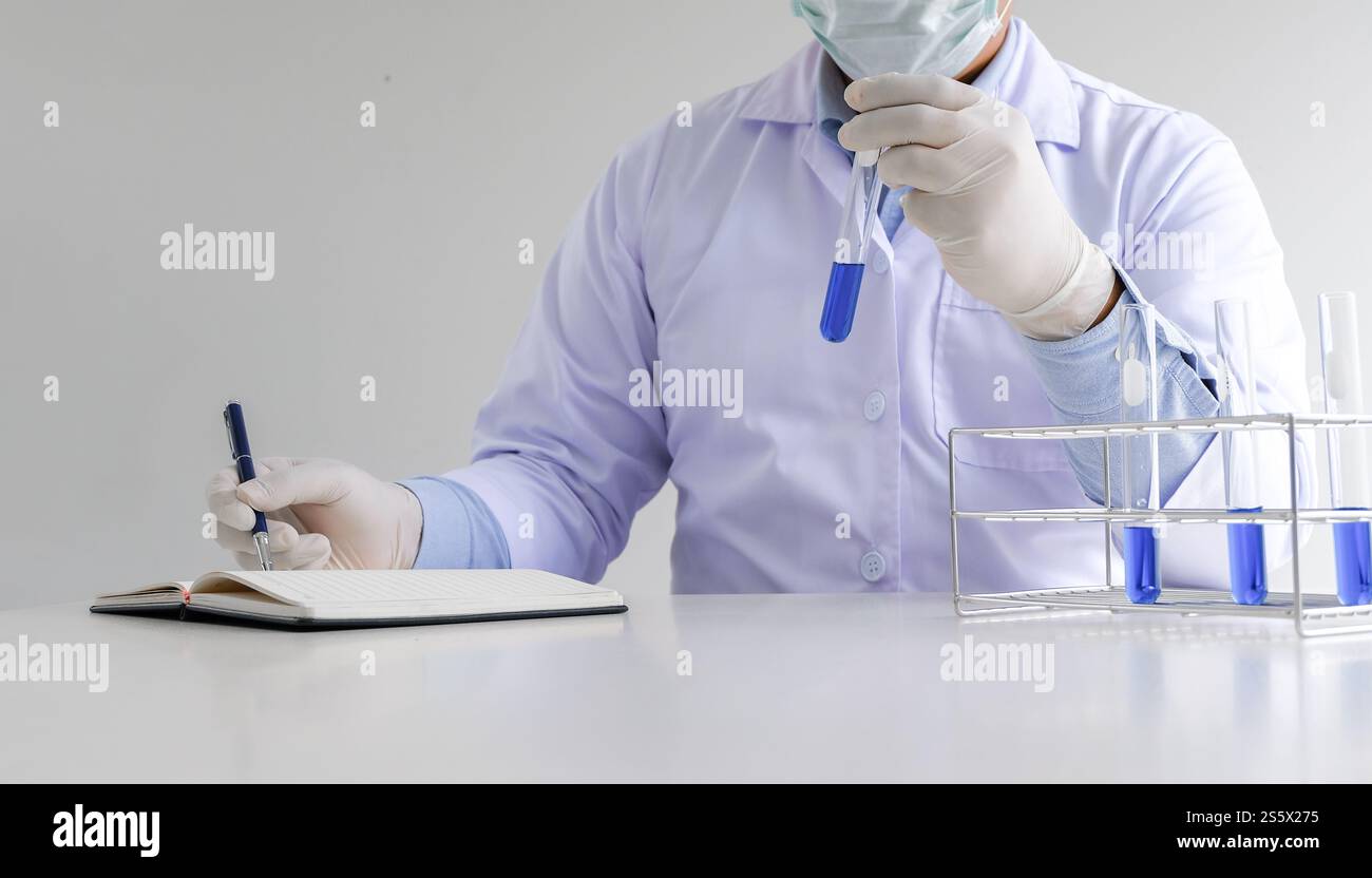 Science innovative Male medical or scientific laboratory researcher performs tests with liquid in laboratory. equipment science experiments Stock Photo